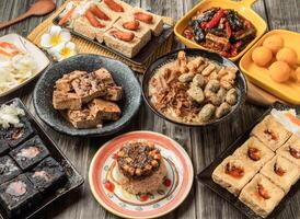 Taiwan food variety Braised Stinky Tofu, Wonton Mee Sua, vegetarian rice cake, Fried Black Stinky Tofu with Kimchi, Stinky Tofu Wrapped Vegetarian Sausage, Fried White Stinky, Spicy Black Stinky photo