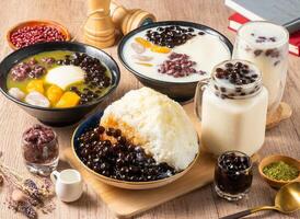Assorted grass belly, mango, taro, soy milk, shaved ice, red beans, rice ball served in bowl isolated on table top view of asian food photo