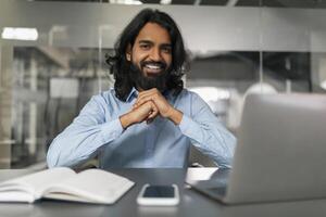 Happy man in office posing for photo