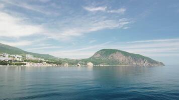 Gurzuf resort city panoramic view on Bear Mountain, Ayu-Dag, Yalta, Crimea. Spring sunny day. Nature summer ocean sea beach background. Vacation, travel and holiday concept. video