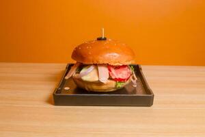 Encantos Burger served in dish isolated on table top view of fastfood photo