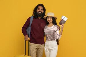 Traveling couple with luggage and passports photo