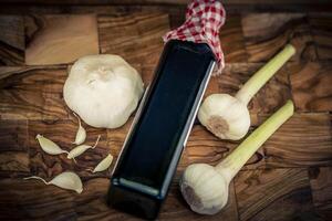 fresh Garlic for garlicoil on olive wood photo