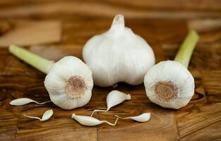 fresh Garlic for garlicoil on olive wood photo