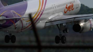 PHUKET, THAILAND - JANUUARY 25, 2023. Passenger plane Airbus A320-232, HS-TXB of Thai Smile Airlines landing, side view video