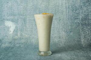 Fresh Malai Lassi served in a glass isolated on grey background top view of bangladesh food photo