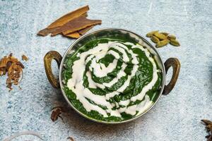 Palak Paneer or saag majhani served in a karahi isolated on grey background top view of bangladesh food photo