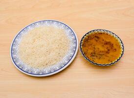 dal chawal or white rice served in dish isolated on table top view indian spicy food photo