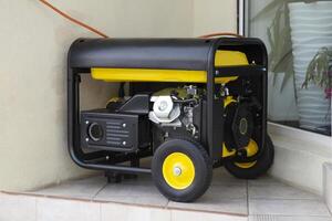 Portable electric generator running in the cold winter.Energy genocide. Power outage as a result of missile strikes by Russia on energy facilities of Ukraine. Small business use gasoline generators. photo