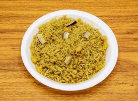 gur walay chawal or gud rice served in plate isolated on table top view of indian and pakistani sweet food photo