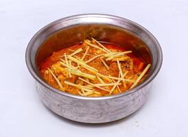 chicken ginger handi served in dish isolated on grey background top view of pakistani food photo