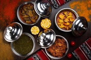 Assorted indian food with alu mutter, bhindi, keema, palak, saag and bhutta served in dish isolated on table top view of arabic food photo