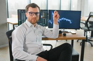 Serious business man trader analyst looking at computer monitor, investor broker analyzing indexes, financial chart trading online investment data on cryptocurrency stock market graph on pc screen. photo