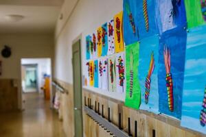 Schwabisch Gmund, Germany-November 12,2022.children's drawings hanging in the hallway of a German school. photo