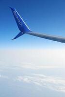 Belavia Airline's Winglet Soaring Above Clouds. Minsk, Belarus- August 20, 2023 photo