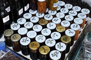 Hand-Labeled Jars of Homemade Preserves on Display. Adatepe, Turkey - August 21, 2023 photo