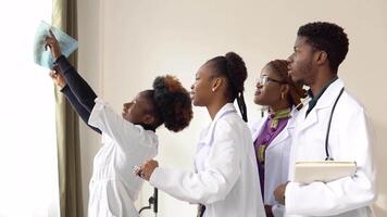 A group of four african american students discuss an x-ray video