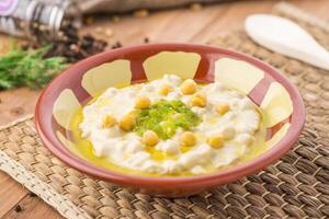 rosary food hummus or mezzeh with chickpea served in dish isolated on table side view of arabic food photo