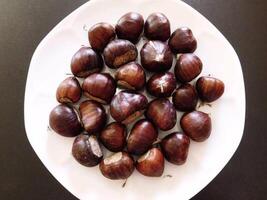 Chestnuts on wooden background video