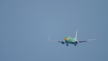 PHUKET, THAILAND - NOVEMBER 28, 2019. Boeing 737-8FH, HS-DBG of Nok Air approaching landing at Phuket airport , HKT, long shot. Aircraft is flying. Travel concept video