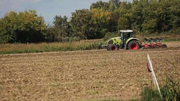 vilanova del gebbo Itália 30 setembro 2022 trator com grade sistema aração terra em cultivado Fazenda campo preparando solo para plantio Novo colheita agricultura conceito video