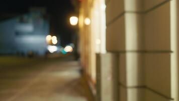 Nighttime Urbanity. Blurry 4K Footage of Pedestrians on City Sidewalk After Dark video