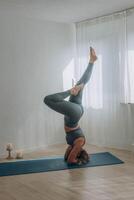 A 50-year-old woman does yoga at home photo