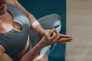 A 50-year-old woman does yoga at home photo