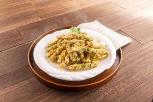 Golden Crispy Kidney Beans served dish isolated on wooden table top view of Hong Kong food photo