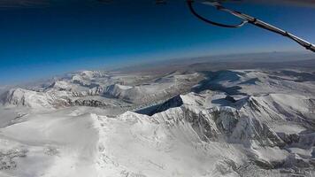 The plane flies over the Himalayan mountains. The tops of the mountains are covered with snow. The area of the eight-thousandth Shishabangma. Tibet. video