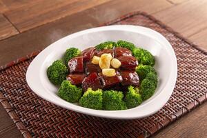 Maoxiang braised pork served dish isolated on wooden table top view of Hong Kong food photo