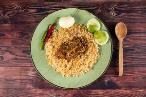 spicy beef pulao, polao, biryani, mandi, kacchi with egg and salad served in dish isolated on table top view of indian food photo