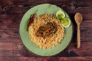 spicy beef pulao, polao, biryani, mandi, kacchi with egg and salad served in dish isolated on table top view of indian food photo