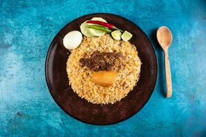 spicy beef pulao, polao, biryani, mandi, kacchi with egg and salad served in dish isolated on table top view of indian food photo