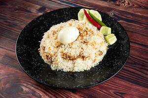 spicy Egg pulao, polao, biryani, mandi, kacchi with egg and salad served in dish isolated on table top view of indian food photo