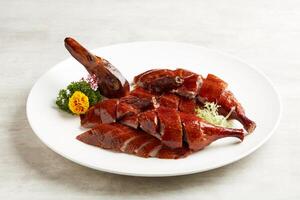 Osmanthus-infused Crispy Roasted Duck served in a dish isolated on grey background photo