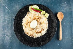 spicy Egg pulao, polao, biryani, mandi, kacchi with egg and salad served in dish isolated on table top view of indian food photo