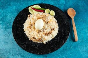 spicy Egg pulao, polao, biryani, mandi, kacchi with egg and salad served in dish isolated on table top view of indian food photo