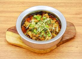 chicken boneless achari handi served in a dish isolated on grey background side view of indian, pakistani food photo