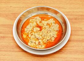 Maghaz or brain with lemon and ginger slice served in a dish isolated on wooden table side view of indian, pakistani food photo