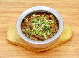 Mutton boneless handi served in a dish isolated on grey background side view of indian, pakistani food photo