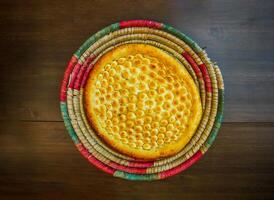 Tandoori garlic naan served in basket isolated on table top view of india and pakistani food photo