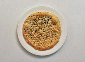 kalonji naan or kalwangi naan served in a dish isolated on grey background top view of indian, pakistani food photo