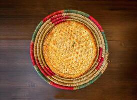 Tandoori special roghni naan served in basket isolated on table top view of india and pakistani food photo