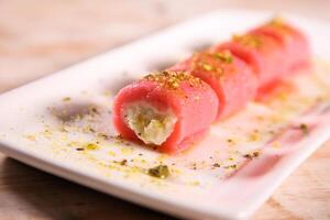 Halawat al jibin bil ward sweet served in dish isolated on table top view of arabic dessert photo