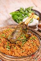 Machboos Laham biryani with lamb chop served in dish isolated on table top view of arab food photo