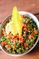 Taboula or tabouleh and tabbouleh salad served in dish isolated on background top of arabic food cold mezza photo