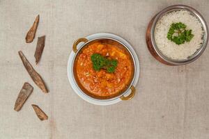 Jhinga rashun masala or prawn curry garvy with white rice served in a dish isolated on table top view of indian spices food photo