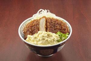 Tar Tar Katsu Don served in a dish isolated on wooden table background side view of singapore food photo