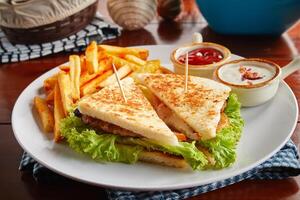 Smoke Chicken sandwich with fries, ketchup, mayo dip sauce served in a dish isolated on wooden background side view photo